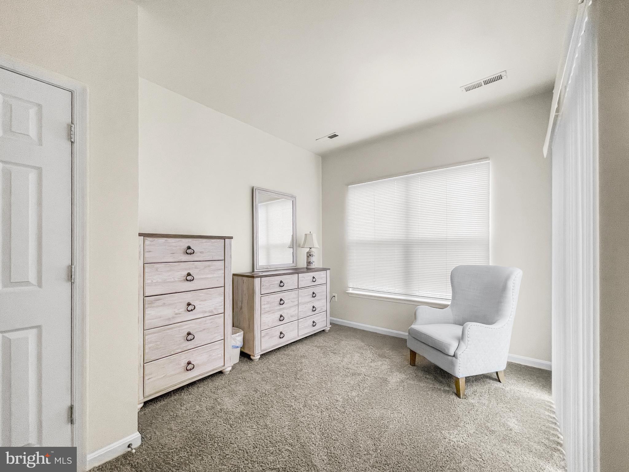 12 South Exeter Street, Unit 140 Baltimore, MD 21202 - Photo 19 of 30 a living room with furniture and a window