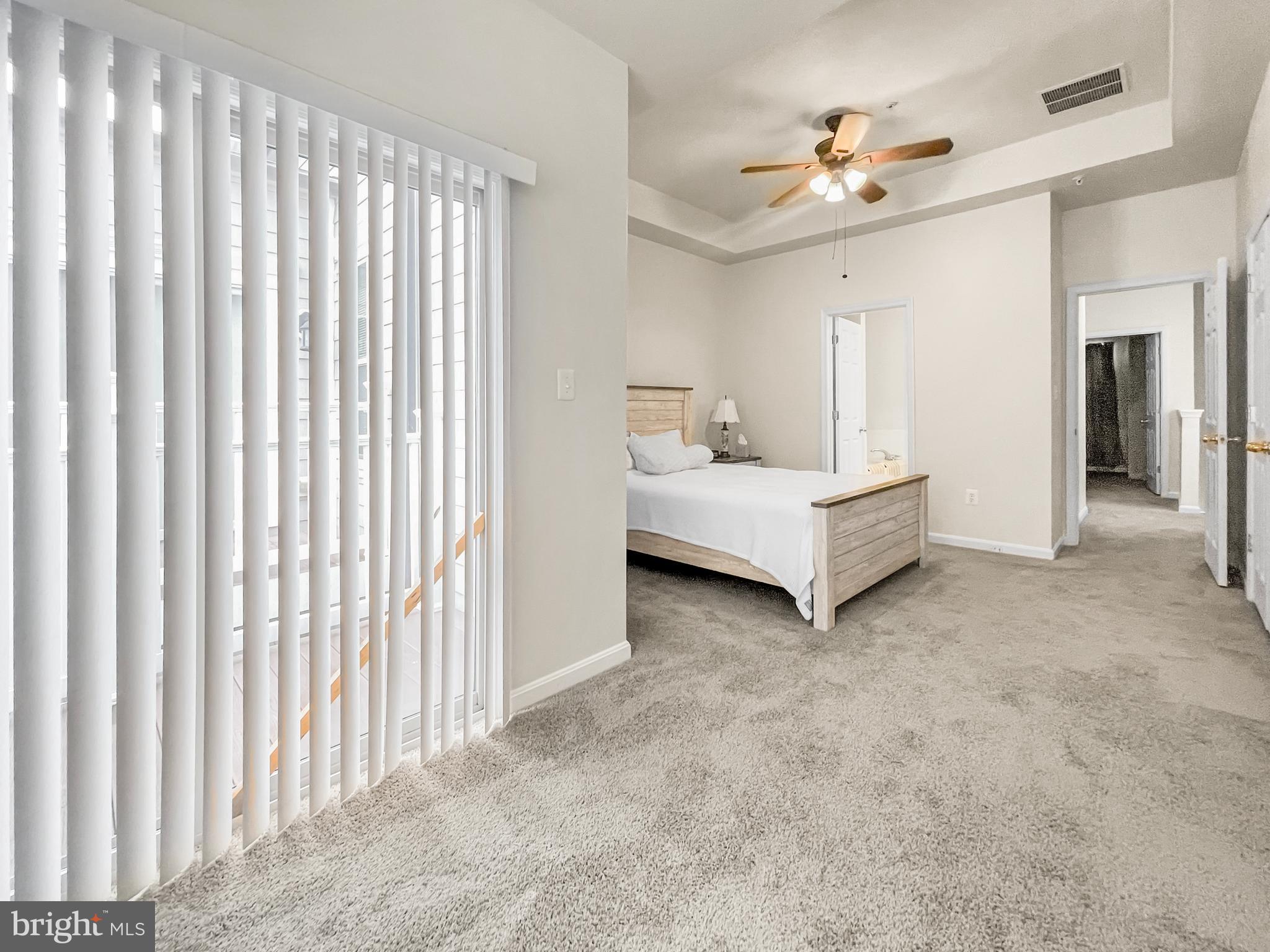 12 South Exeter Street, Unit 140 Baltimore, MD 21202 - Photo 20 of 30 a living room with a bed and a chandelier