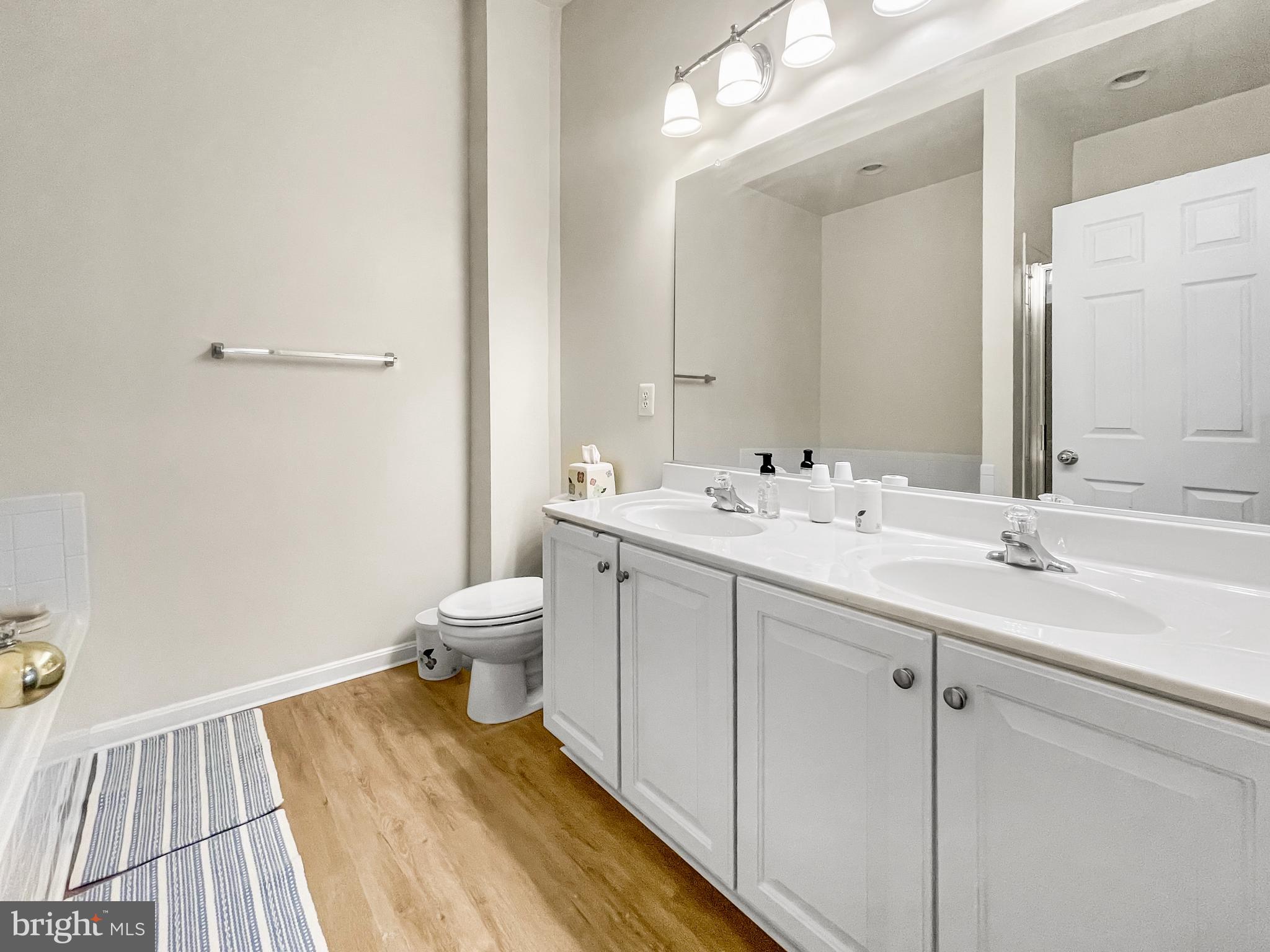 12 South Exeter Street, Unit 140 Baltimore, MD 21202 - Photo 21 of 30 a bathroom with a sink a toilet and a mirror