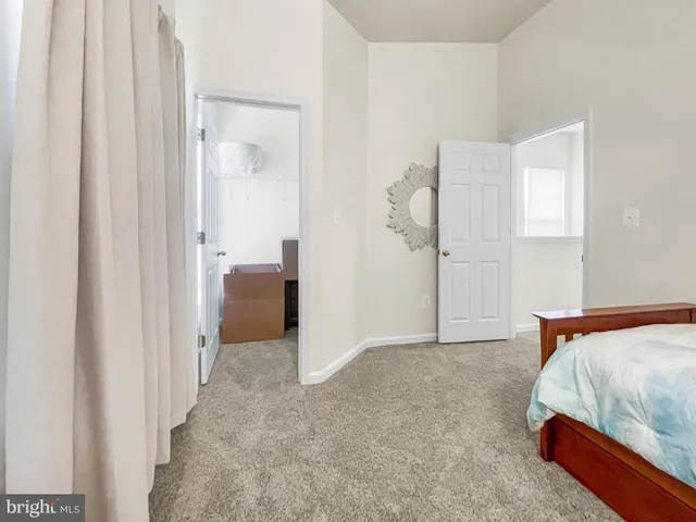 a bathroom with a sink a toilet a mirror and shower