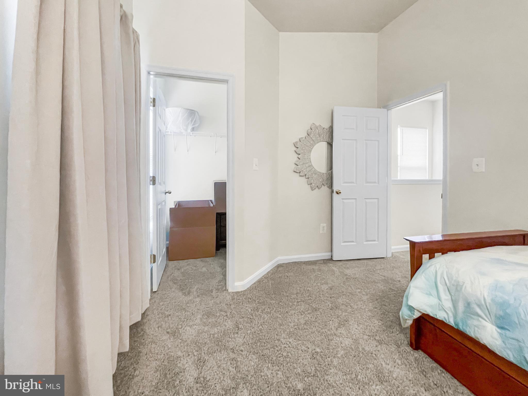 12 South Exeter Street, Unit 140 Baltimore, MD 21202 - Photo 25 of 30 a bedroom with a bed and a cabinets