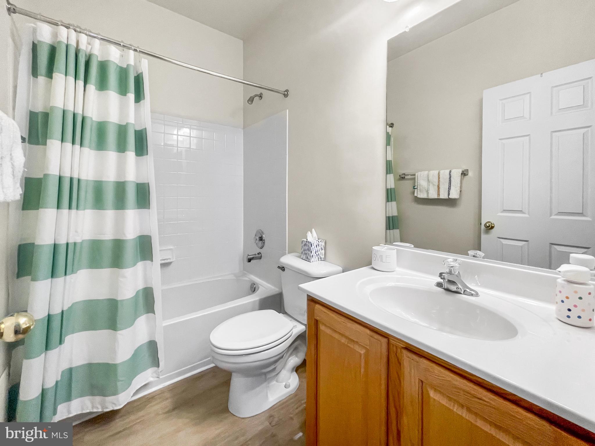 12 South Exeter Street, Unit 140 Baltimore, MD 21202 - Photo 26 of 30 a bathroom with a sink a toilet a mirror and shower