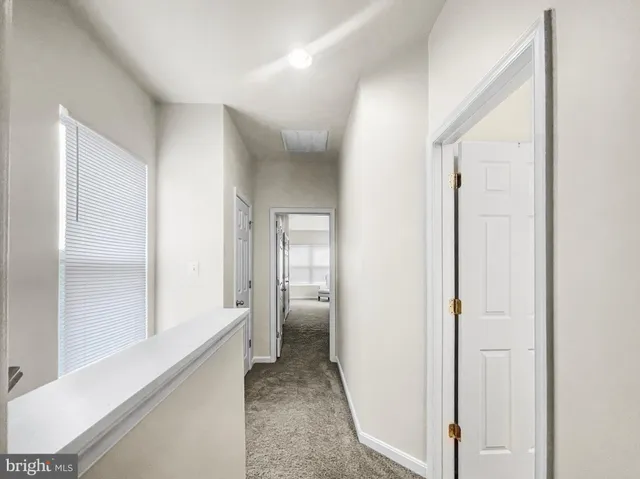 a view of a hallway with a white walls