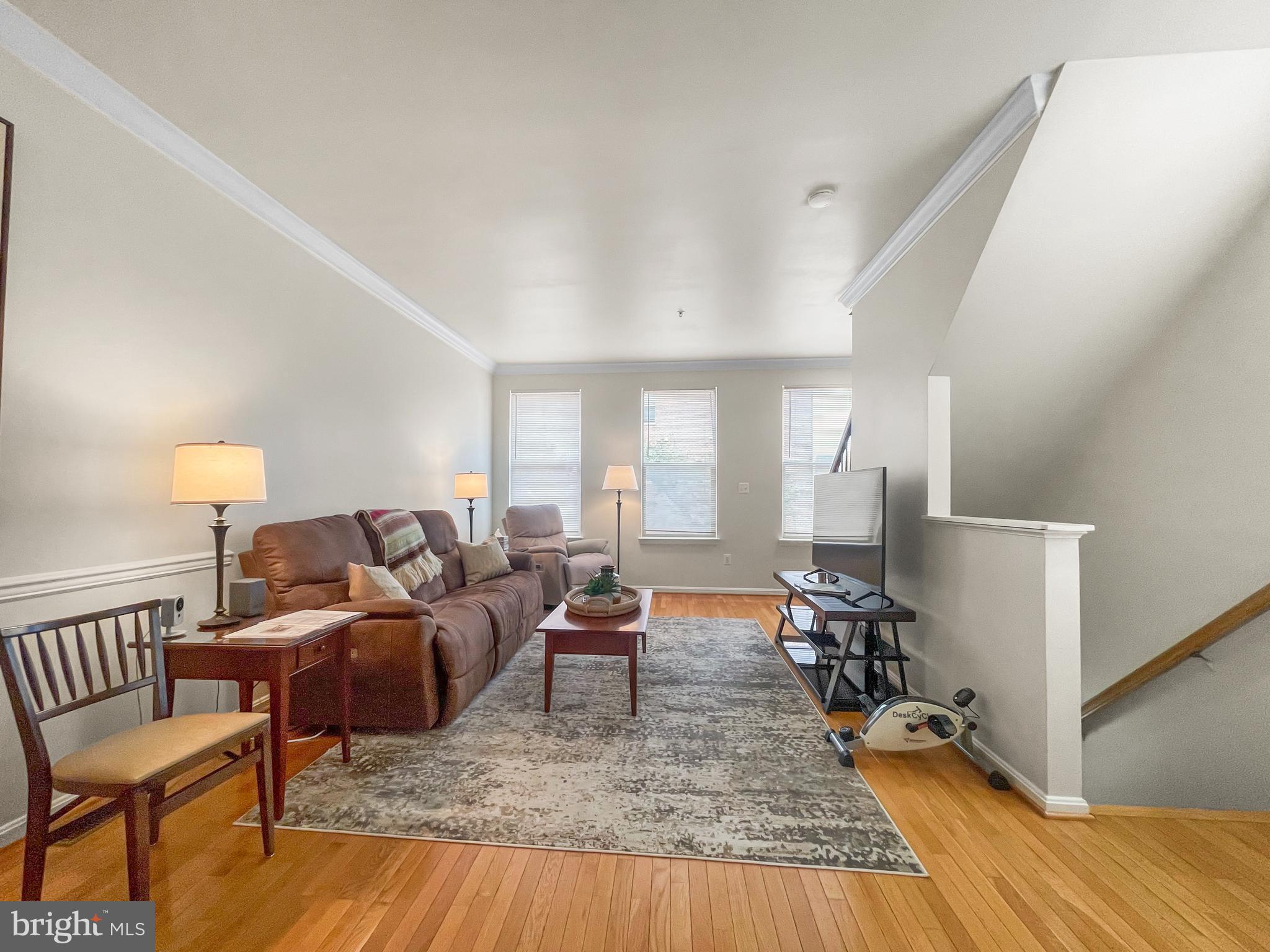 12 South Exeter Street, Unit 140 Baltimore, MD 21202 - Photo 9 of 30 a living room with furniture and a wooden floor