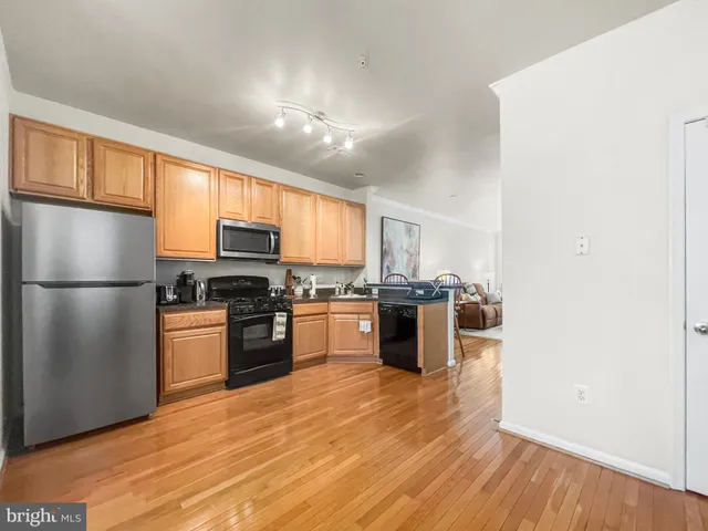 a kitchen with granite countertop stainless steel appliances and wooden cabinets