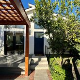 a front view of a building with trees