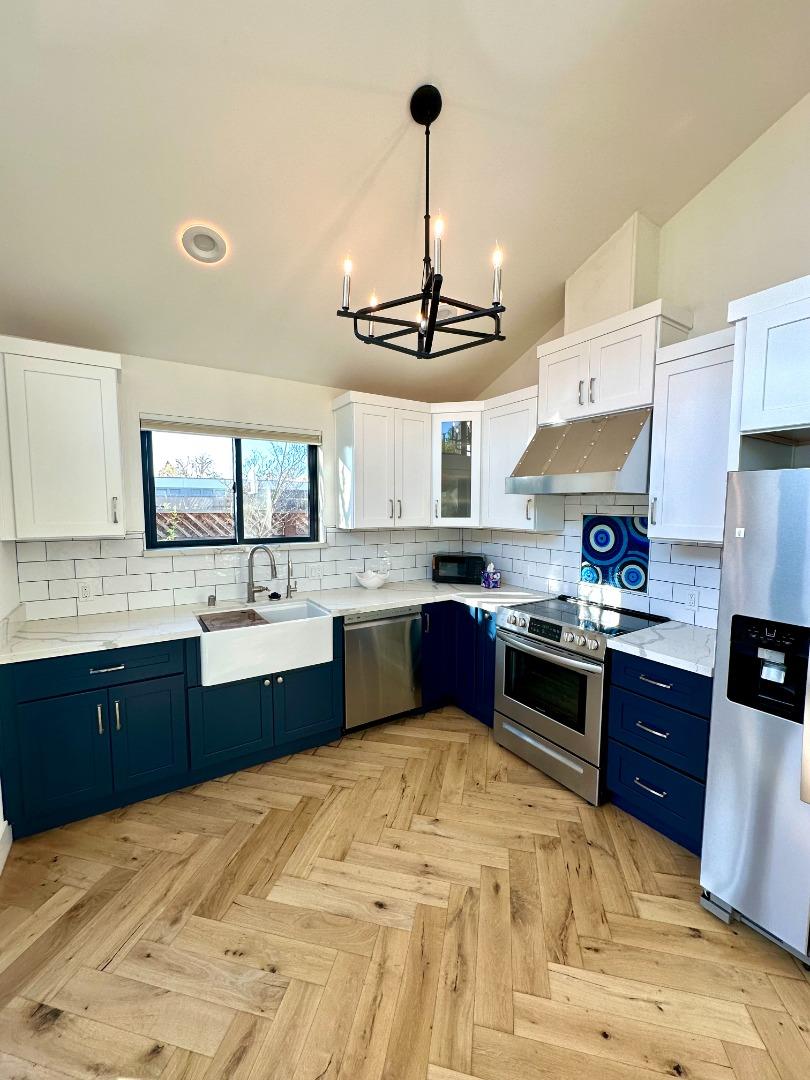 1092 Washington Street Mountain View, CA 94043 - Photo 11 of 32 a large kitchen with stainless steel appliances granite countertop a sink stove and refrigerator