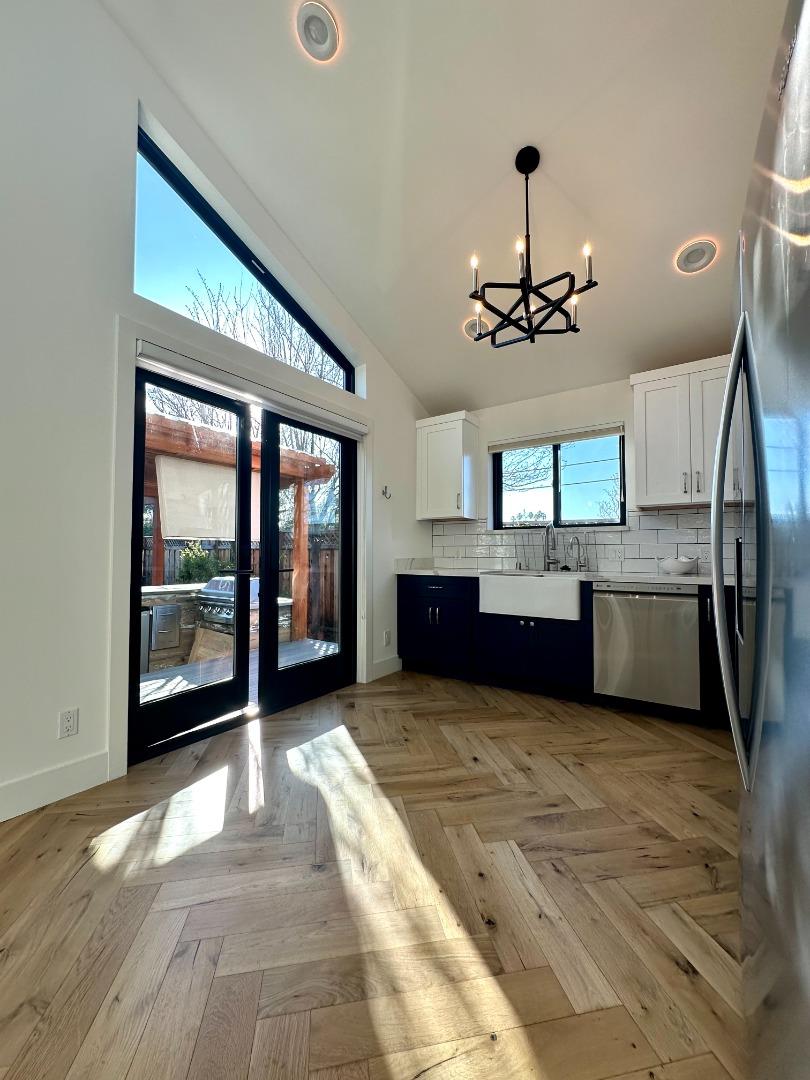 1092 Washington Street Mountain View, CA 94043 - Photo 12 of 32 a view of a kitchen with a sink and dishwasher cabinet with wooden floor