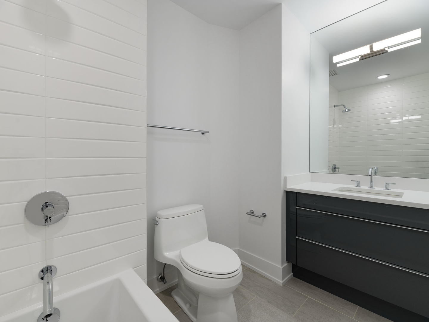 2 West Delaware Place, Unit 2802 Chicago, IL 60610 - Photo 14 of 22 a bathroom with a sink a toilet and mirror