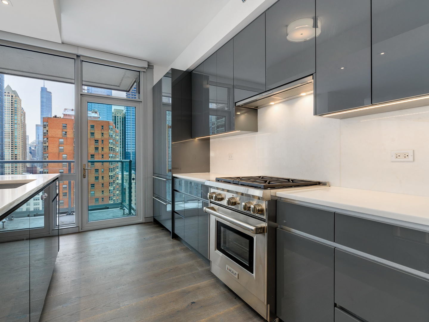 2 West Delaware Place, Unit 2802 Chicago, IL 60610 - Photo 3 of 22 a kitchen with a stove and a wooden floors