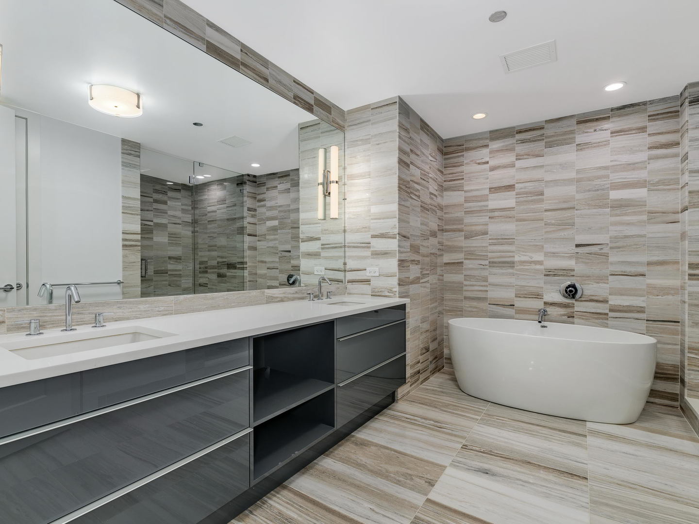 2 West Delaware Place, Unit 2802 Chicago, IL 60610 - Photo 9 of 22 a spacious bathroom with a double vanity sink mirror and bathtub