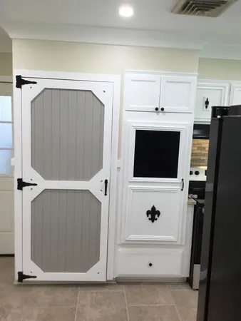 a view of cabinets with stainless steel appliances wooden floor