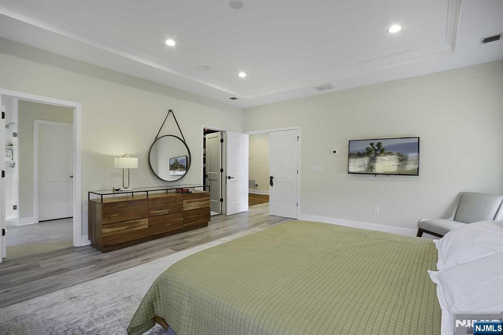 10 Aspen Drive Cedar Grove, NJ 07009 - Photo 19 of 43 a bedroom with a bed and wooden floor