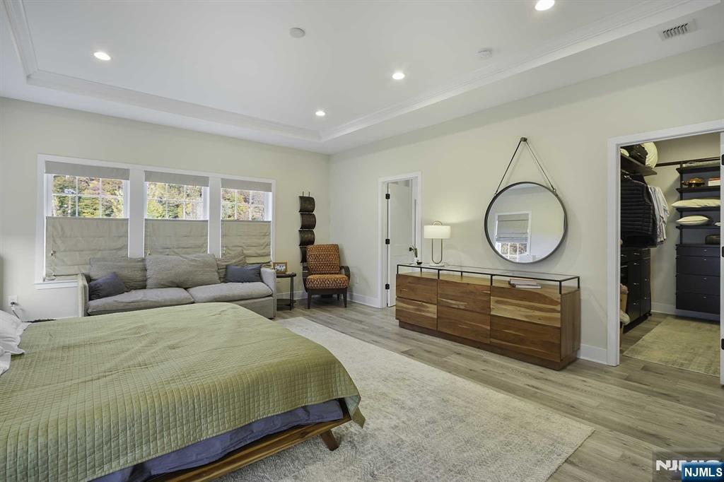 10 Aspen Drive Cedar Grove, NJ 07009 - Photo 21 of 43 a bedroom with a bed a mirror and a window