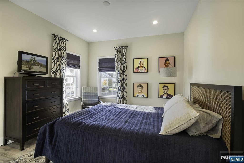 10 Aspen Drive Cedar Grove, NJ 07009 - Photo 26 of 43 a bedroom with a bed and dresser with mirror