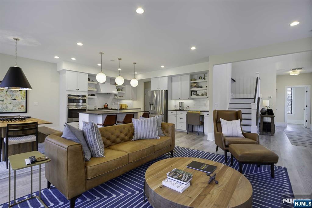 10 Aspen Drive Cedar Grove, NJ 07009 - Photo 7 of 43 a large living room with stainless steel appliances kitchen island furniture and a view of kitchen