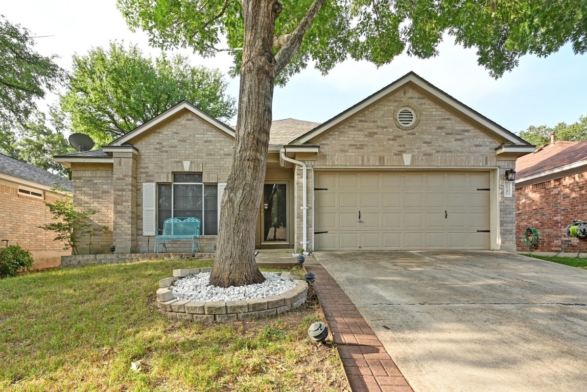 a front view of a house with a yard and garage