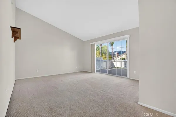 a view of empty room with a fireplace