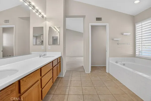 a spacious bathroom with a bathtub and a shower