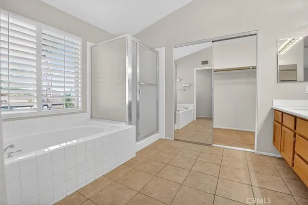 a bathroom with a tub shower and a sink