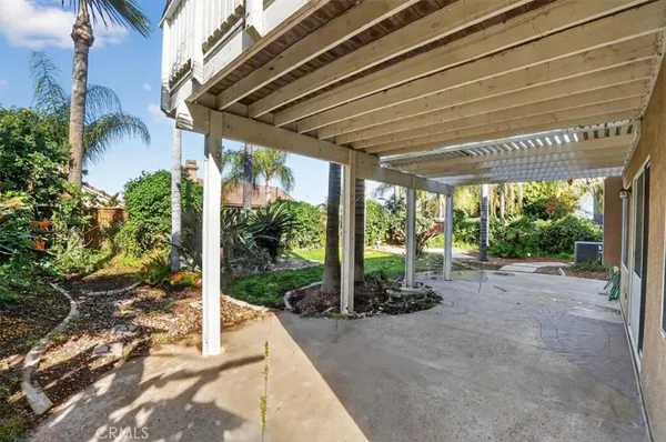 a couple of palm trees sitting in a yard with swimming pool