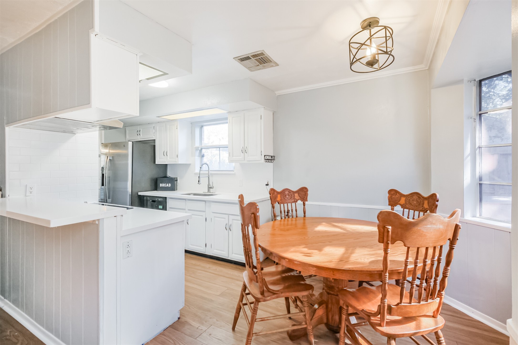 12207 Level Run Street Meadows Place, TX 77477 - Photo 12 of 44 a view of a dining room with furniture and a kitchen