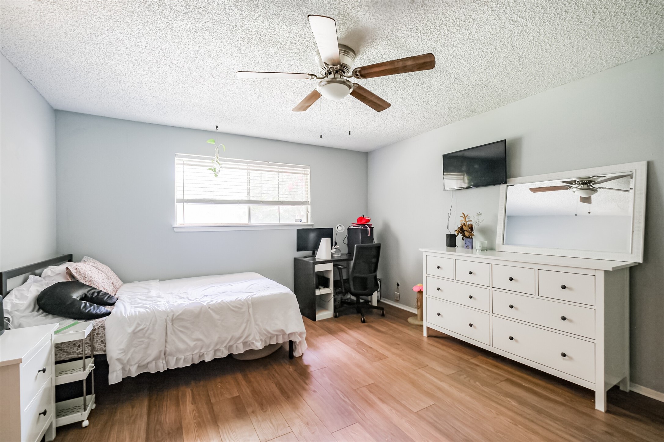 12207 Level Run Street Meadows Place, TX 77477 - Photo 17 of 44 a bedroom with a bed and a dresser