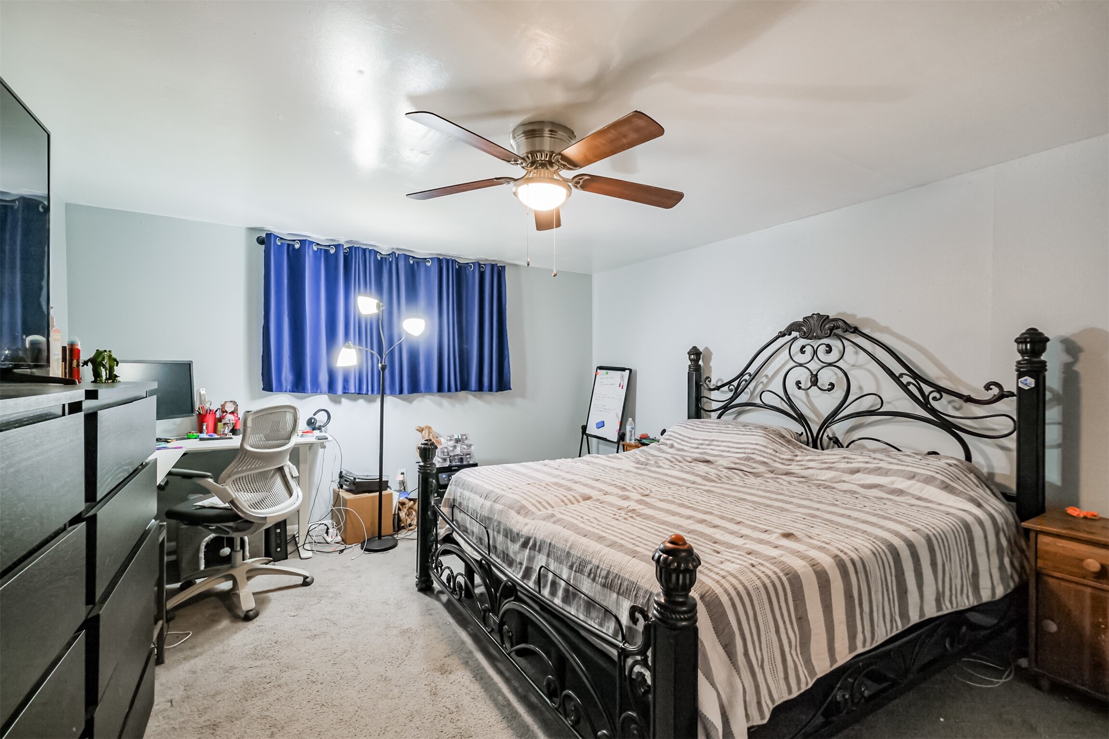 12207 Level Run Street Meadows Place, TX 77477 - Photo 24 of 44 a bedroom with bed and a chandelier