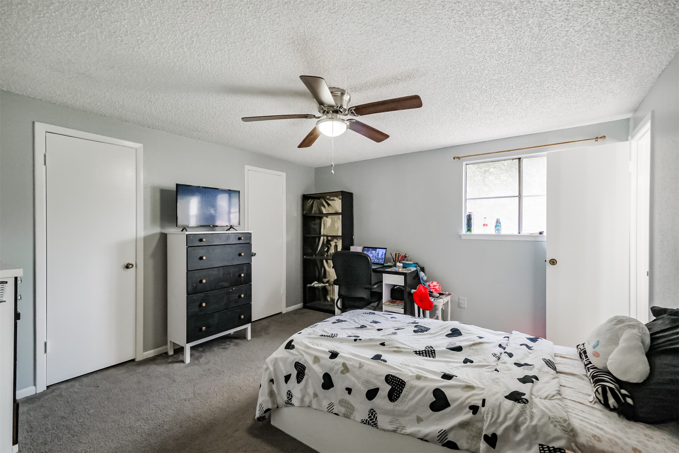 12207 Level Run Street Meadows Place, TX 77477 - Photo 25 of 44 a bedroom with a bed and a dresser