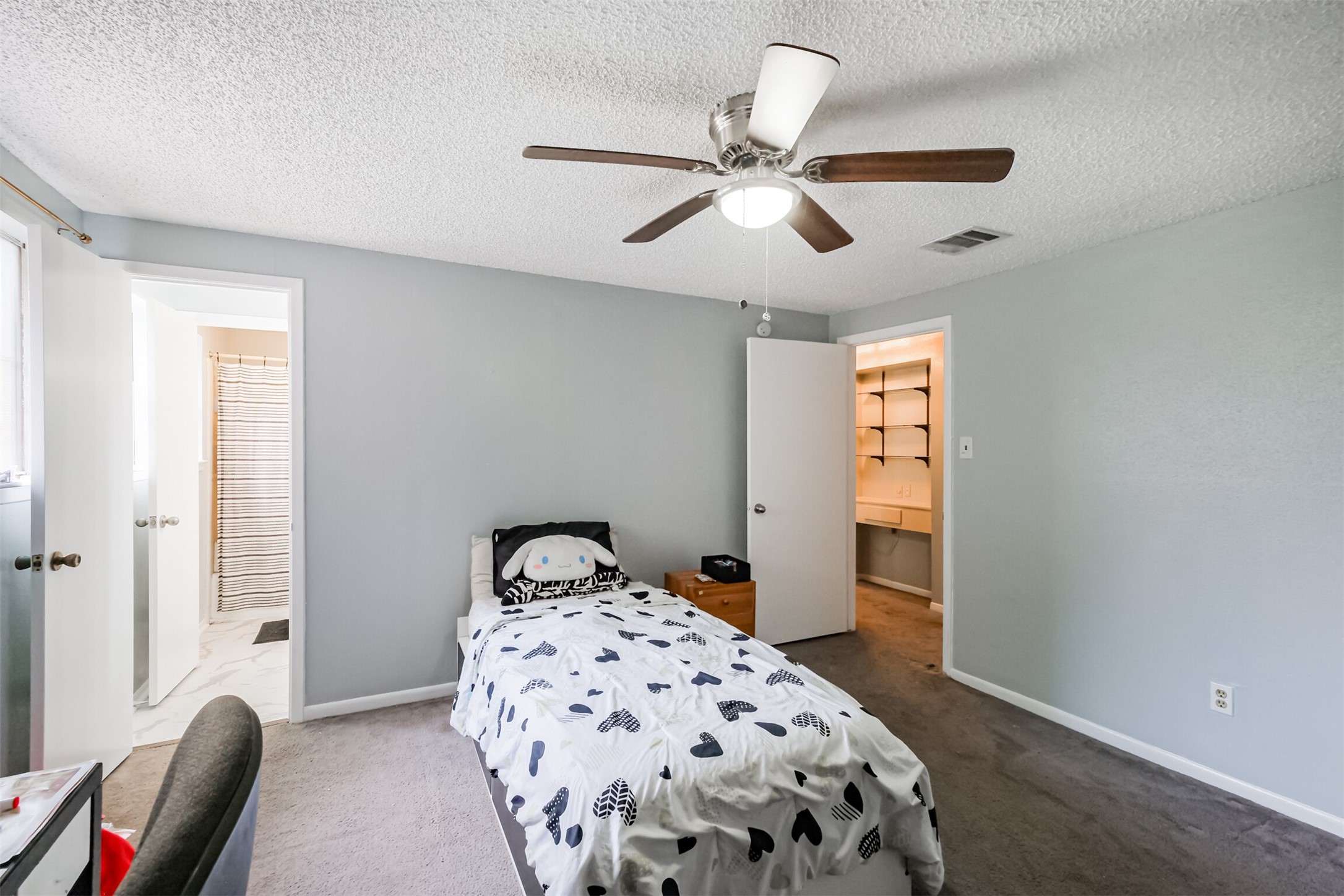 12207 Level Run Street Meadows Place, TX 77477 - Photo 26 of 44 a bedroom with a bed and a chandelier