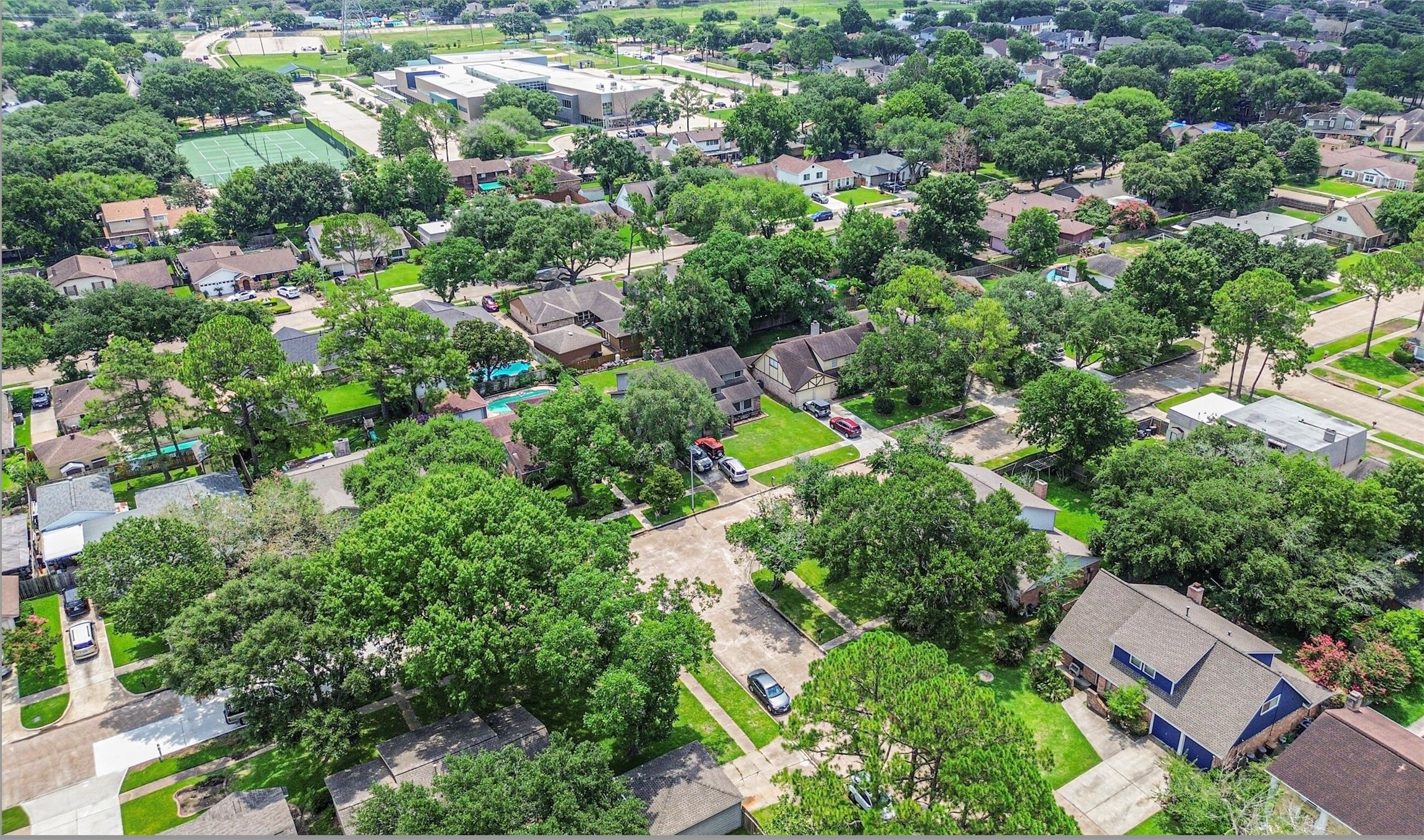 12207 Level Run Street Meadows Place, TX 77477 - Photo 38 of 44 an aerial view of residential house with outdoor space and trees all around