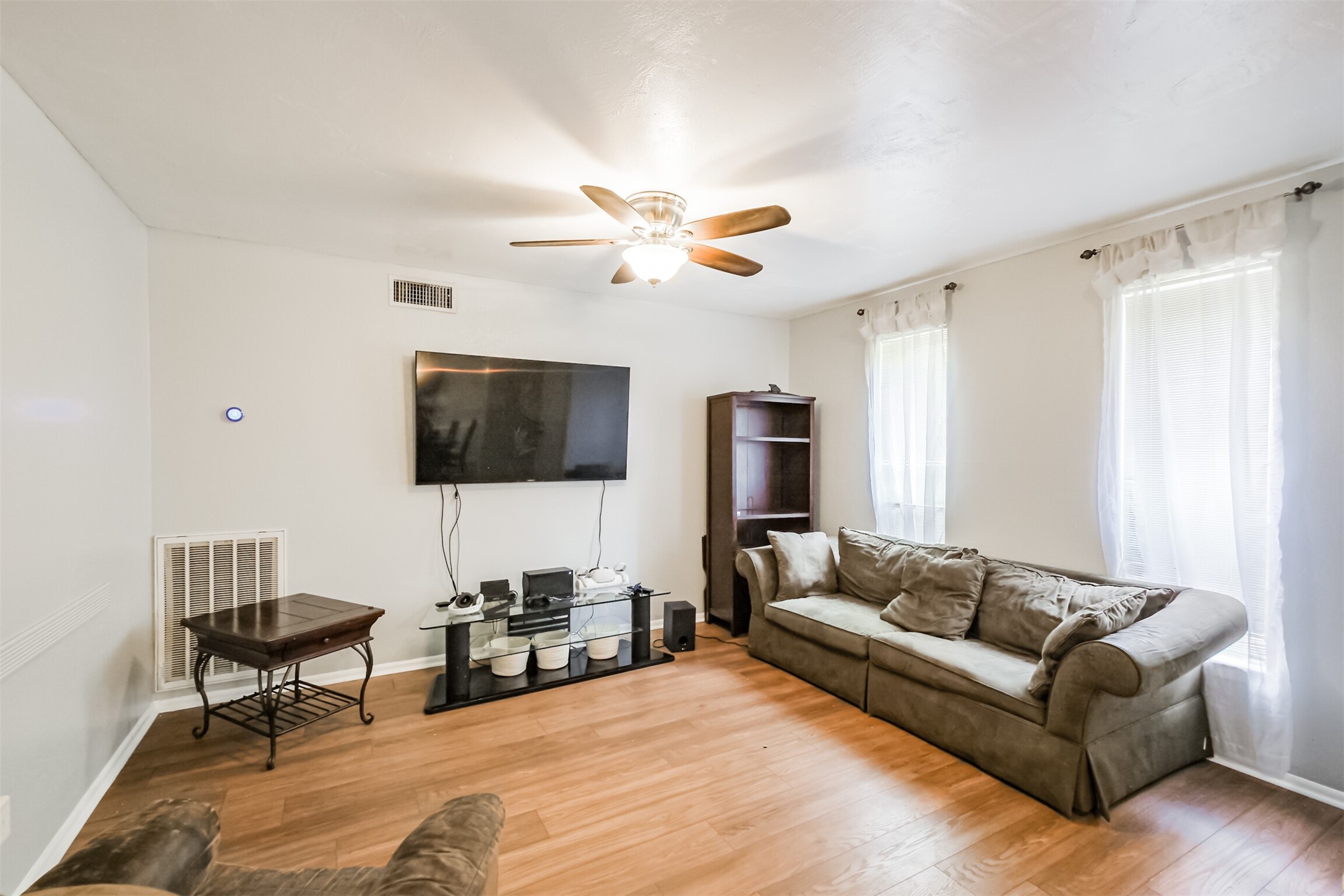 12207 Level Run Street Meadows Place, TX 77477 - Photo 6 of 44 a living room with furniture a flat screen tv and a window