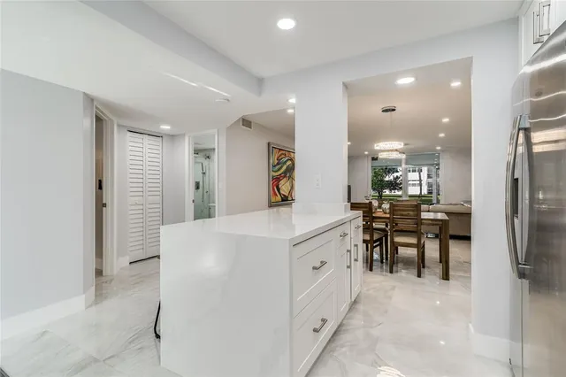 a living room with furniture a flat screen tv and a large window