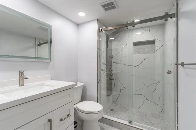 a bathroom with a shower toilet and sink