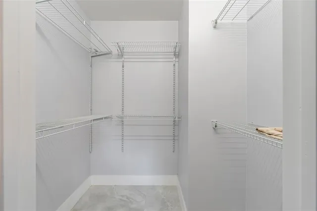 a kitchen with stainless steel appliances kitchen island granite countertop a dining table chairs and sink