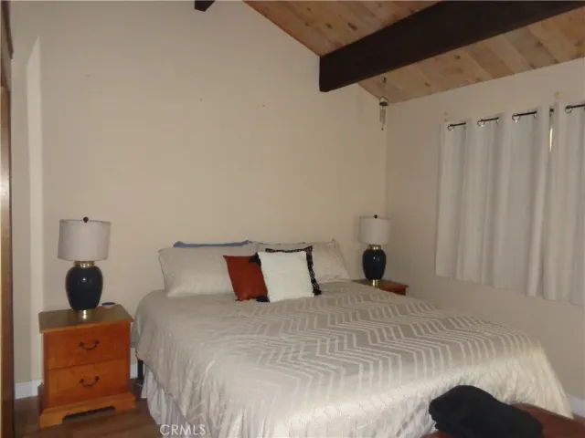 a bedroom with a bed and a mirror