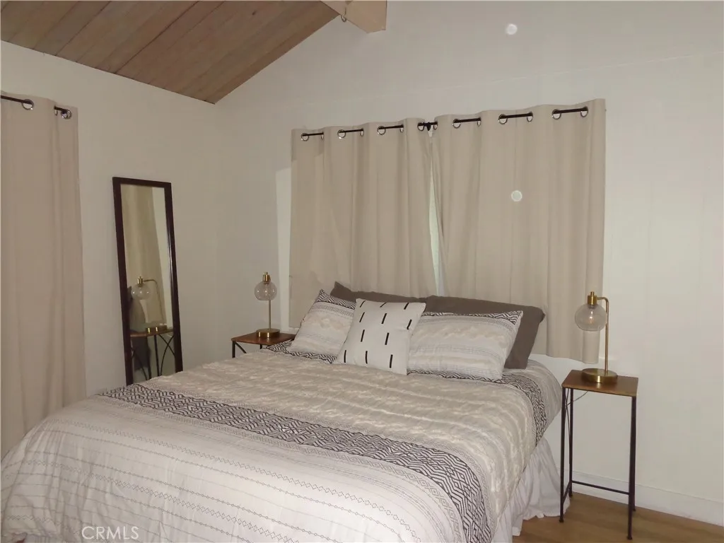 24273 Horst Drive Crestline, CA 92325 - Photo 15 of 34 a bedroom with a bed and a mirror