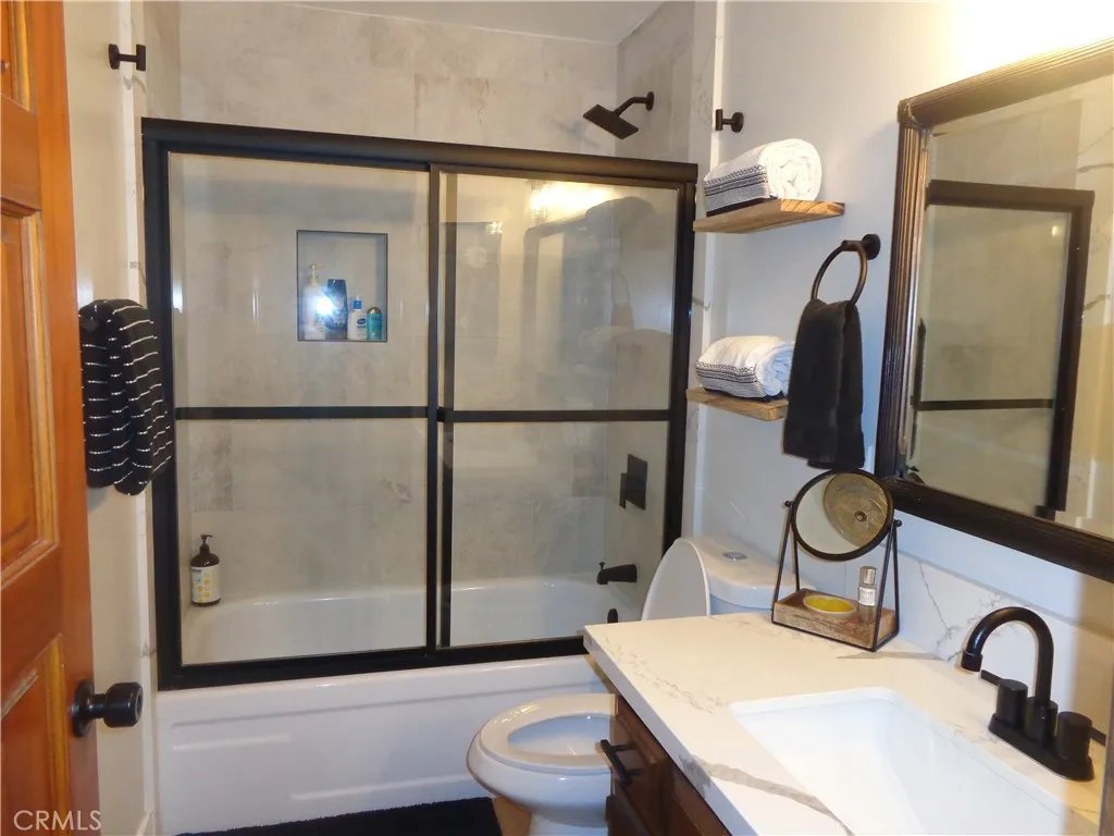 24273 Horst Drive Crestline, CA 92325 - Photo 21 of 34 a bathroom with a sink a toilet and shower