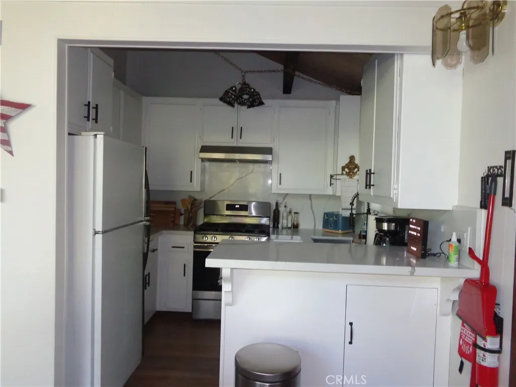 24273 Horst Drive Crestline, CA 92325 - Photo 27 of 34 a kitchen with a refrigerator and a sink