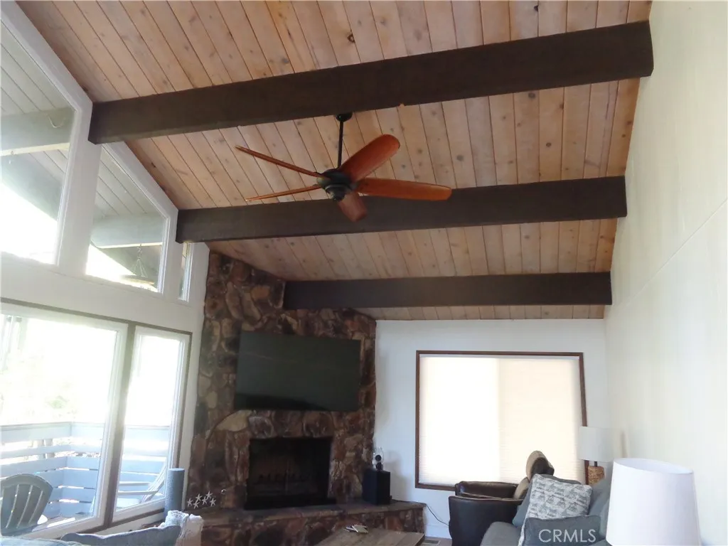 24273 Horst Drive Crestline, CA 92325 - Photo 34 of 34 a living room with furniture a flat screen tv and a fireplace