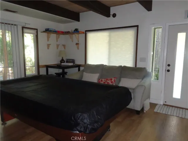 a living room with a bed furniture and a window