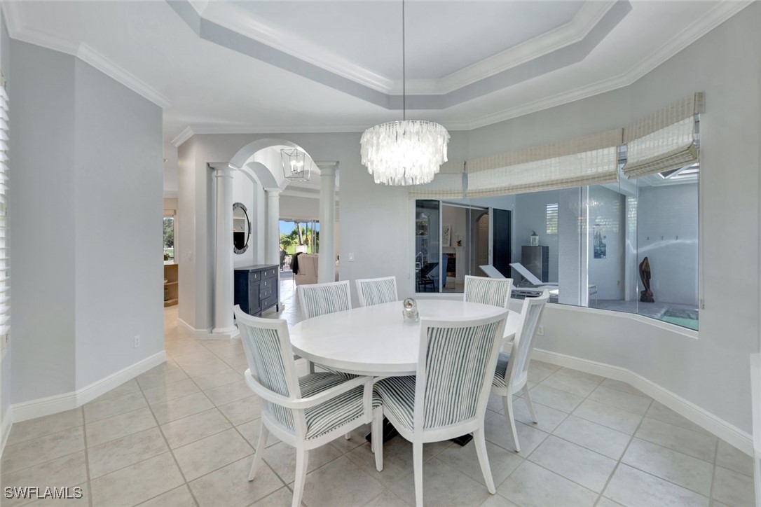 2450 Wulfert Road Sanibel, FL 33957 - Photo 23 of 44 a view of a dining room with furniture and chandelier