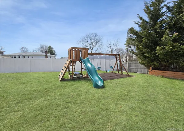a view of a backyard with table and chairs