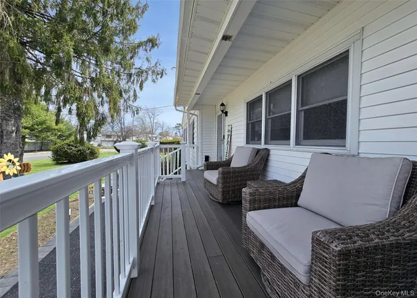 a balcony with furniture and wooden floor