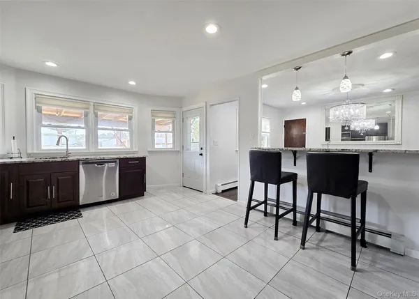 a large kitchen with a table and chairs