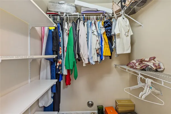 a view of walk in closet with clothes