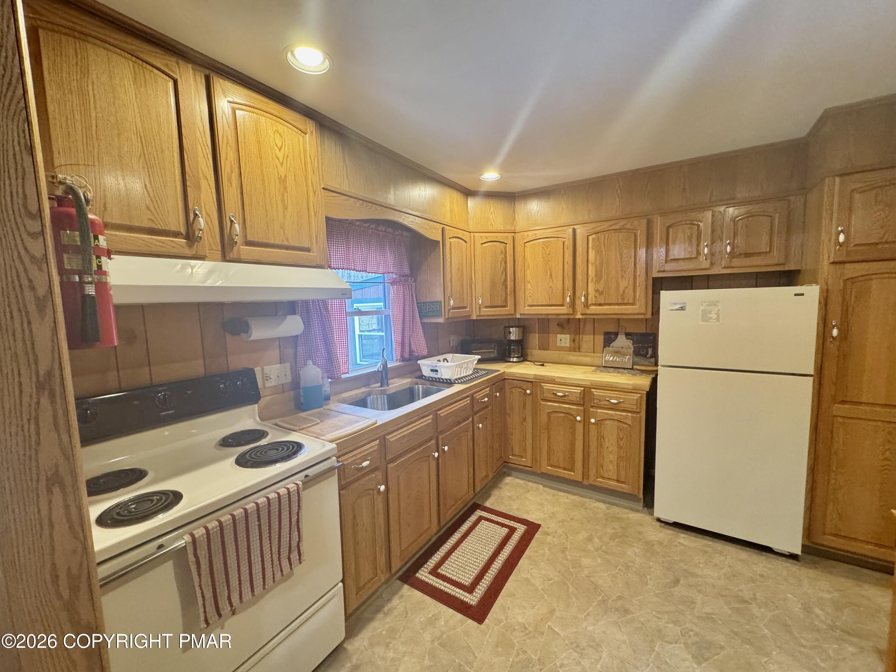 2317 Locust Ridge Road Pocono Lake, PA 18347 - Photo 18 of 49 a kitchen with a sink stove and refrigerator