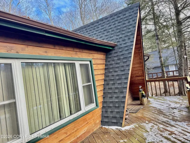 a view of a wooden house with a yard