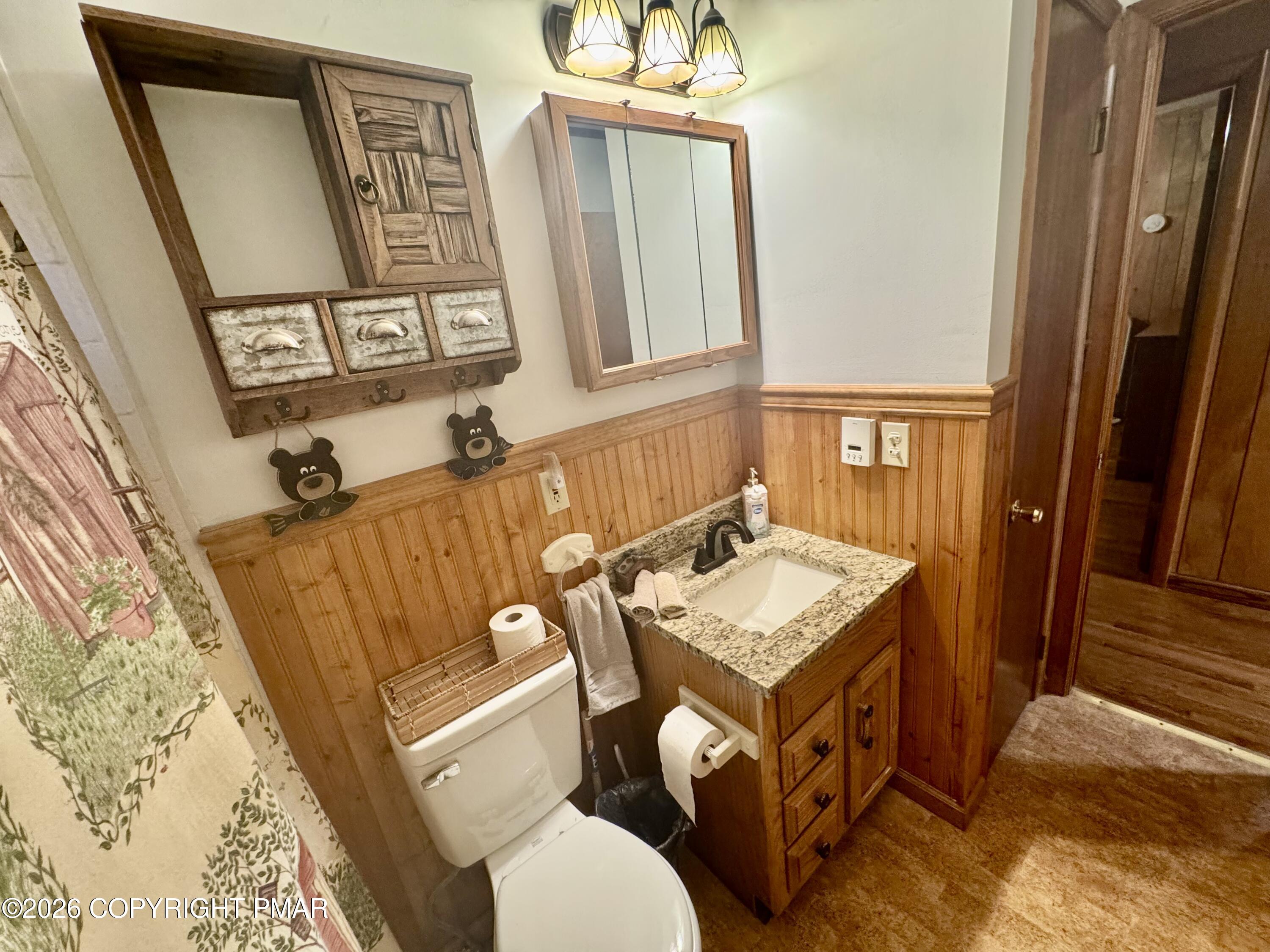2317 Locust Ridge Road Pocono Lake, PA 18347 - Photo 32 of 49 a bathroom with a sink mirror vanity and toilet