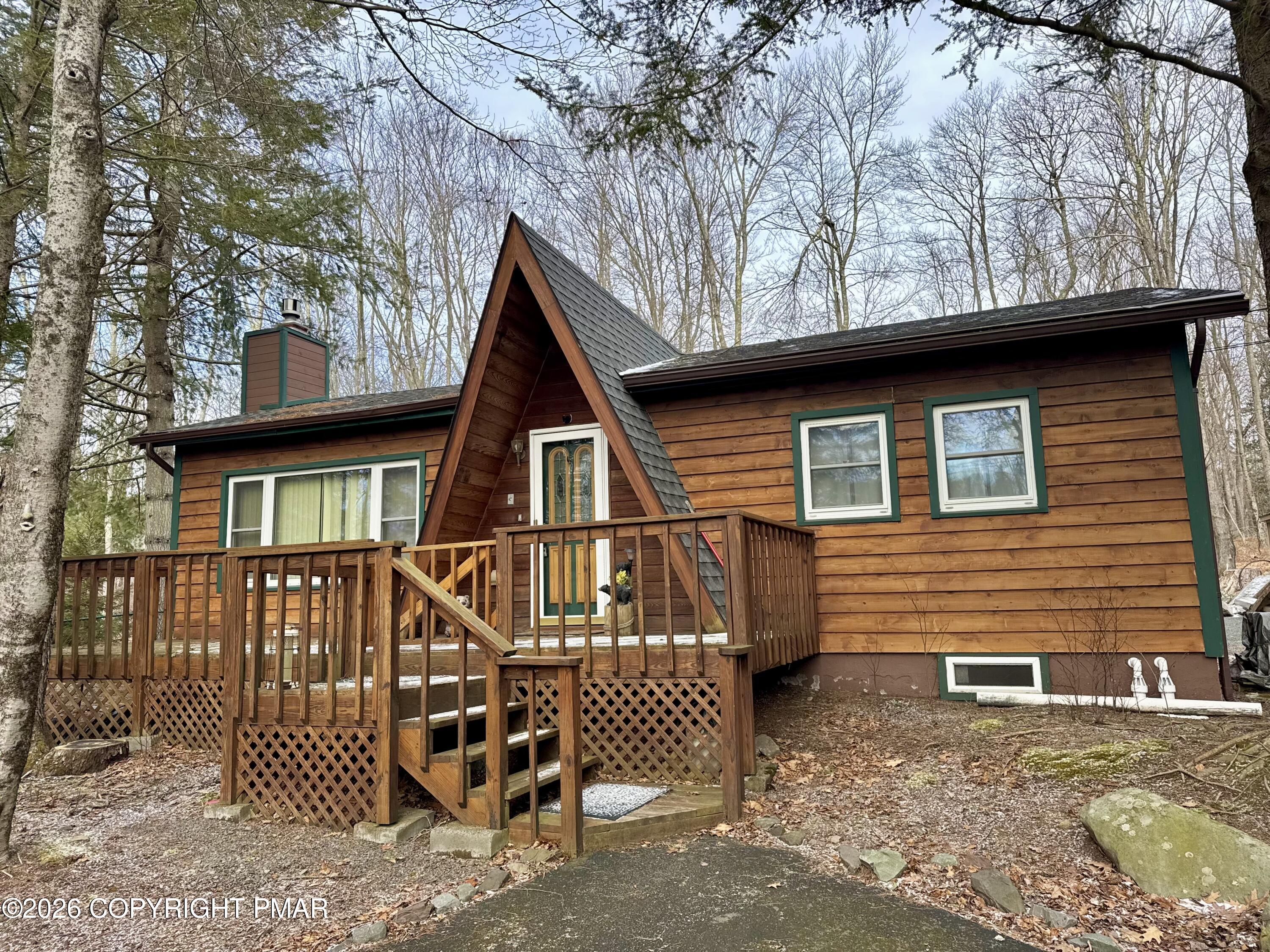2317 Locust Ridge Road Pocono Lake, PA 18347 - Photo 4 of 49 a view of a wooden house with a yard